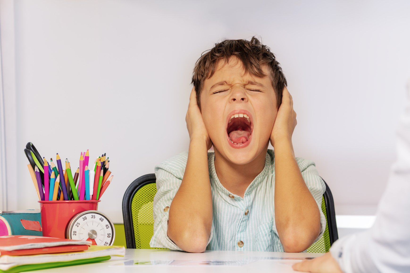 Screaming Boy with Autism Covering Ears Using Hands